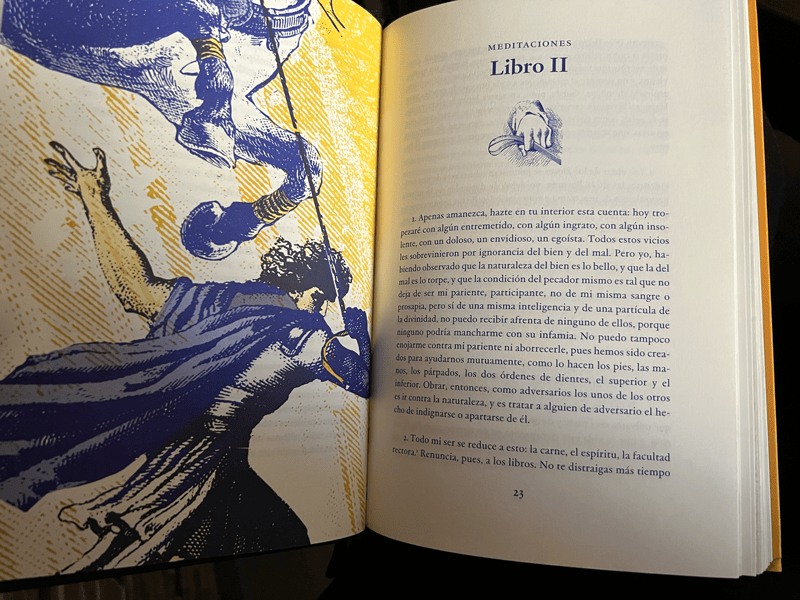 Página abierta del Libro Meditaciones de Marco Aurelio, mostrando el inicio del "Libro II" con una ilustración antigua, invitando a la reflexión estoica.